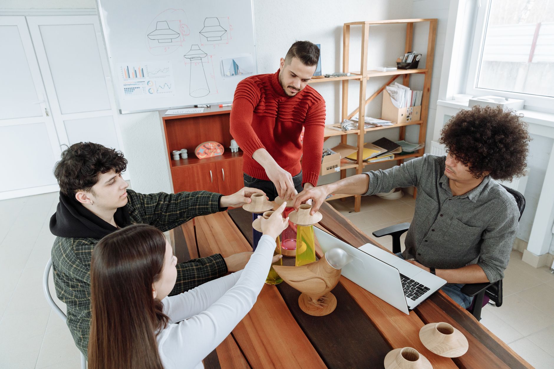 SaaS startup team reviewing a CRM dashboard together in a modern open office