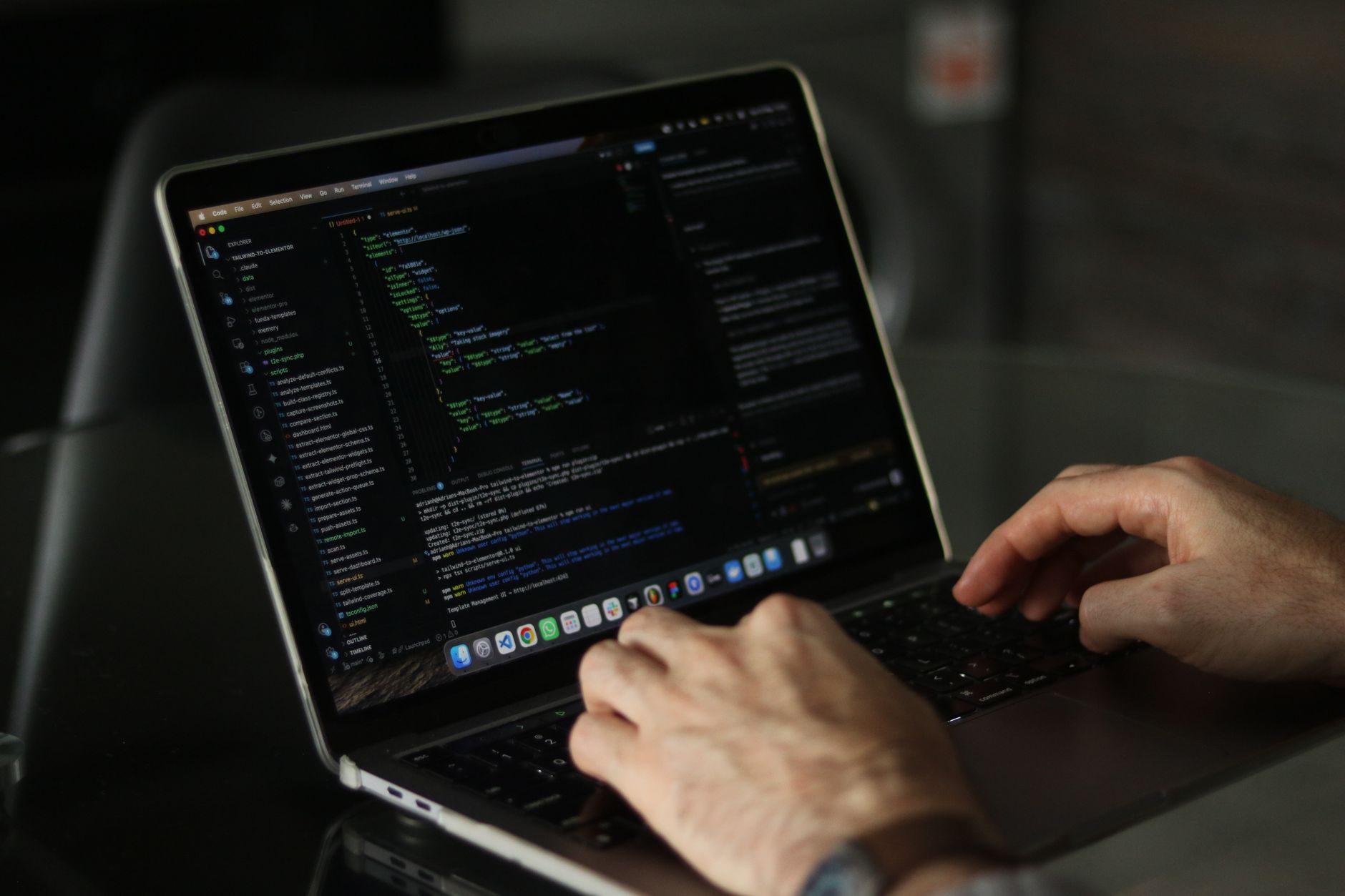Business professional reviewing a contract proposal on a laptop in a modern office