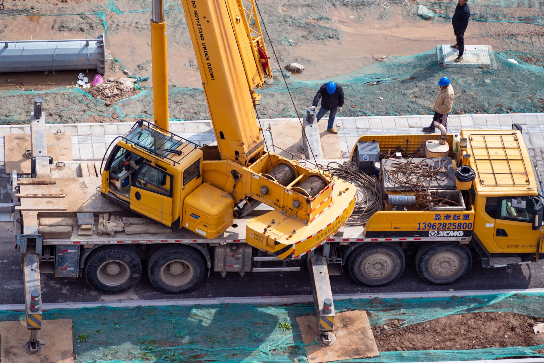 Construction site manager using a CRM on a tablet to track bids