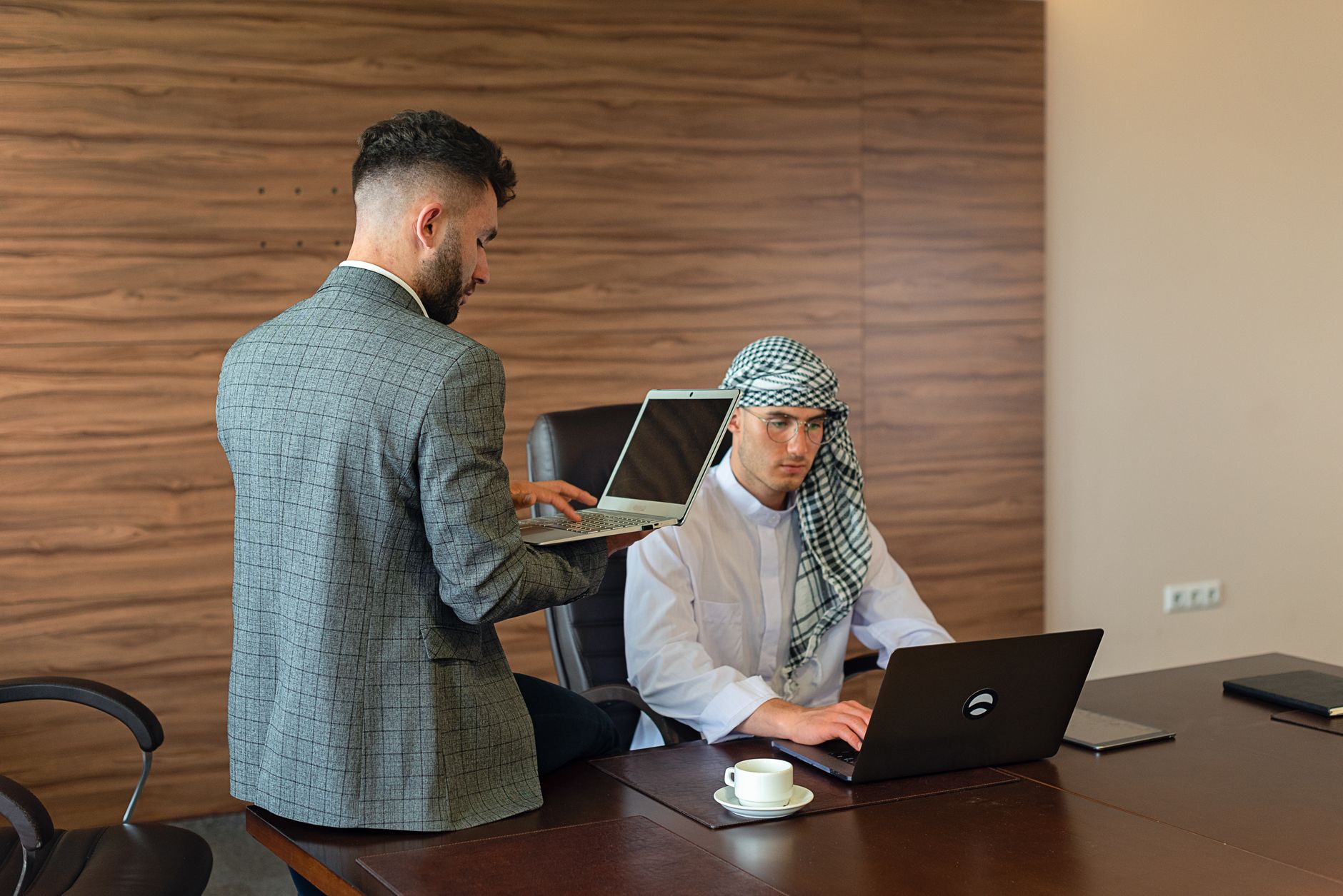 Consultant presenting CRM data to executive team in a boardroom