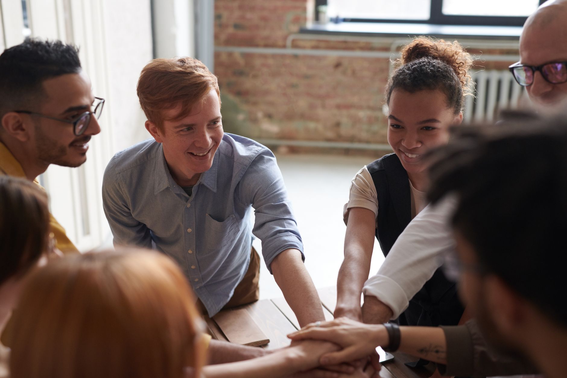 Team gathered around a project board choosing between CRM and PM software