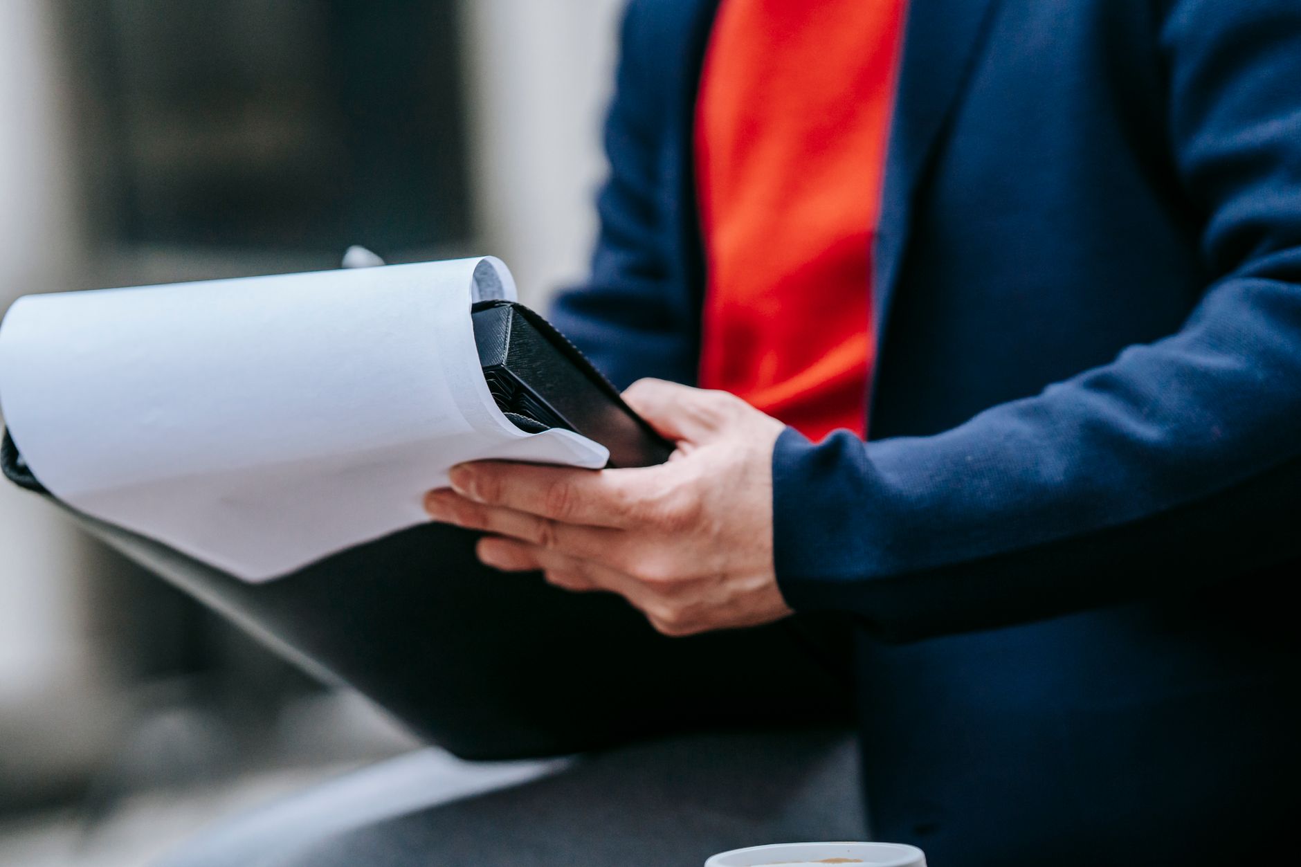 Business buyer using a checklist to evaluate essential CRM features on a laptop