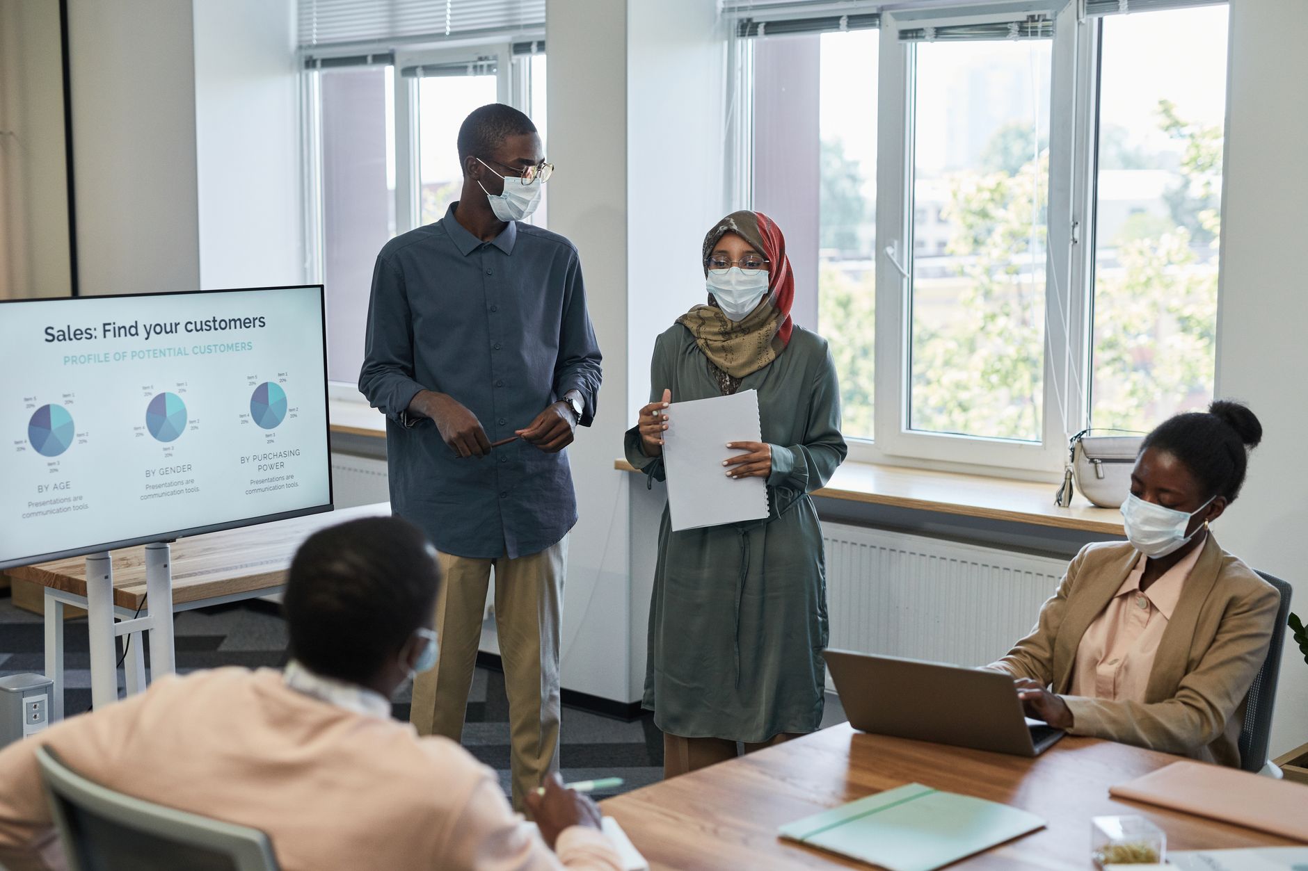 Sales team in a weekly pipeline review meeting around a conference table