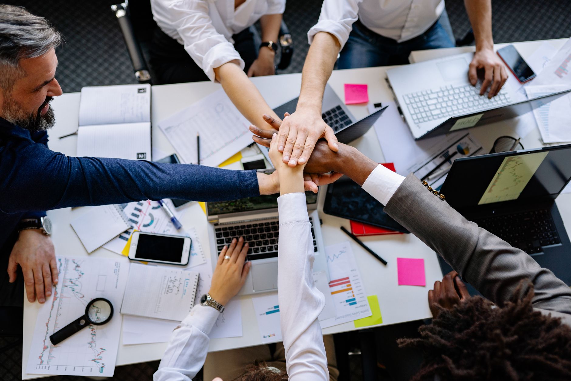 Finance professional reviewing a sales forecast model with a small team
