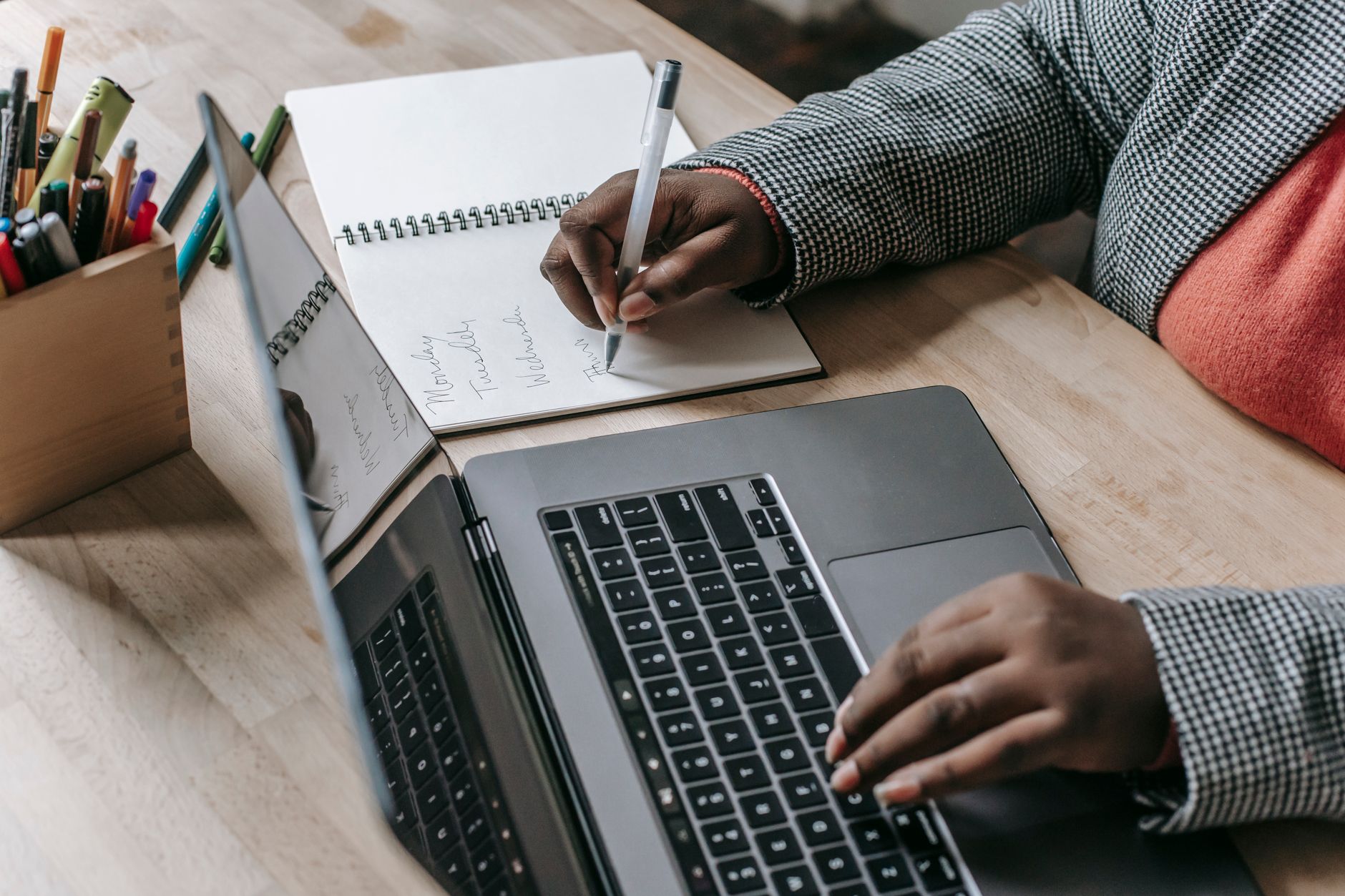 Account manager showing upgrade options to a client on a laptop during a business meeting