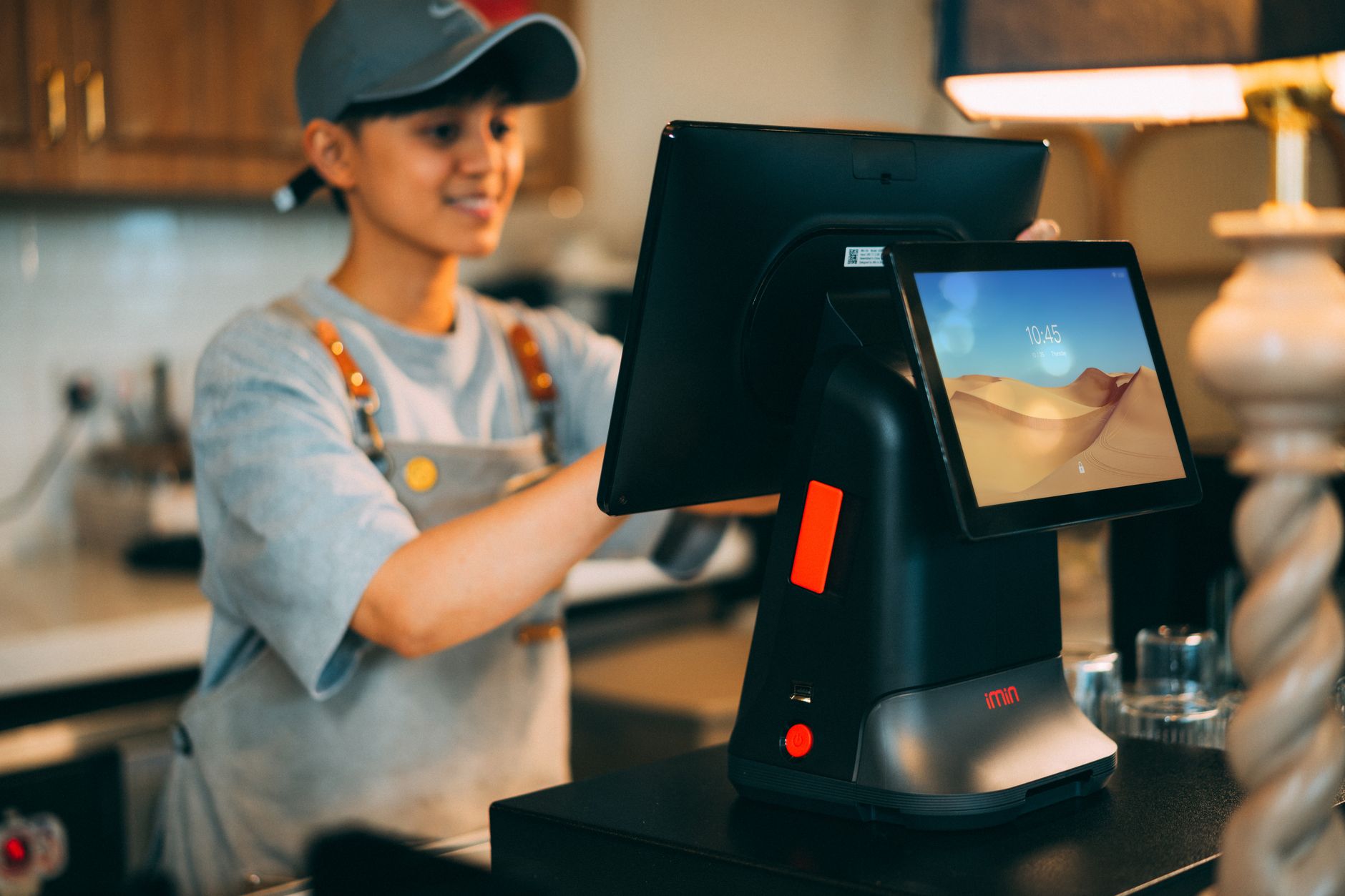 Sales rep with phone and laptop managing a multichannel sales cadence