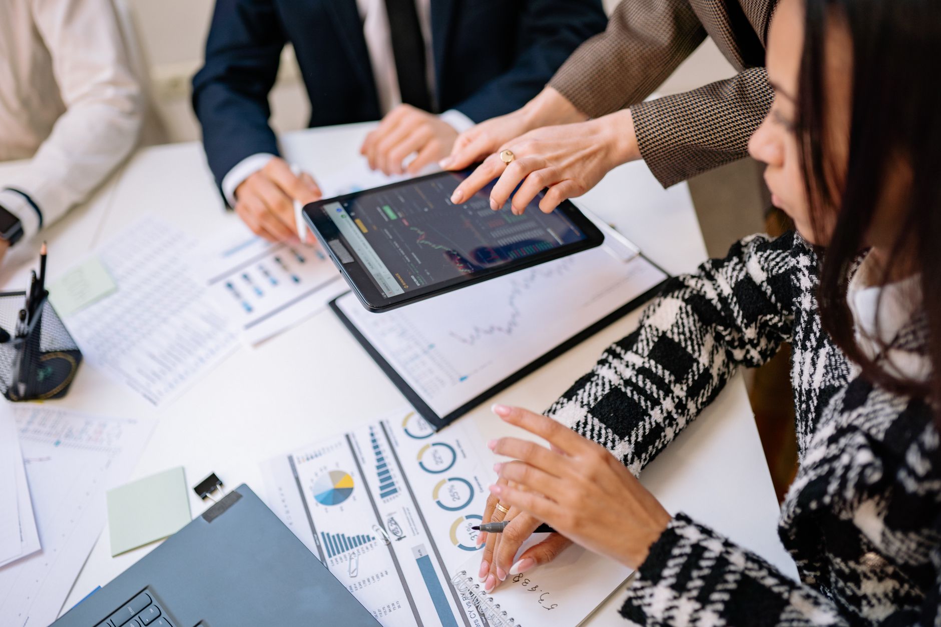 Finance professional reviewing a sales forecast model with a small team