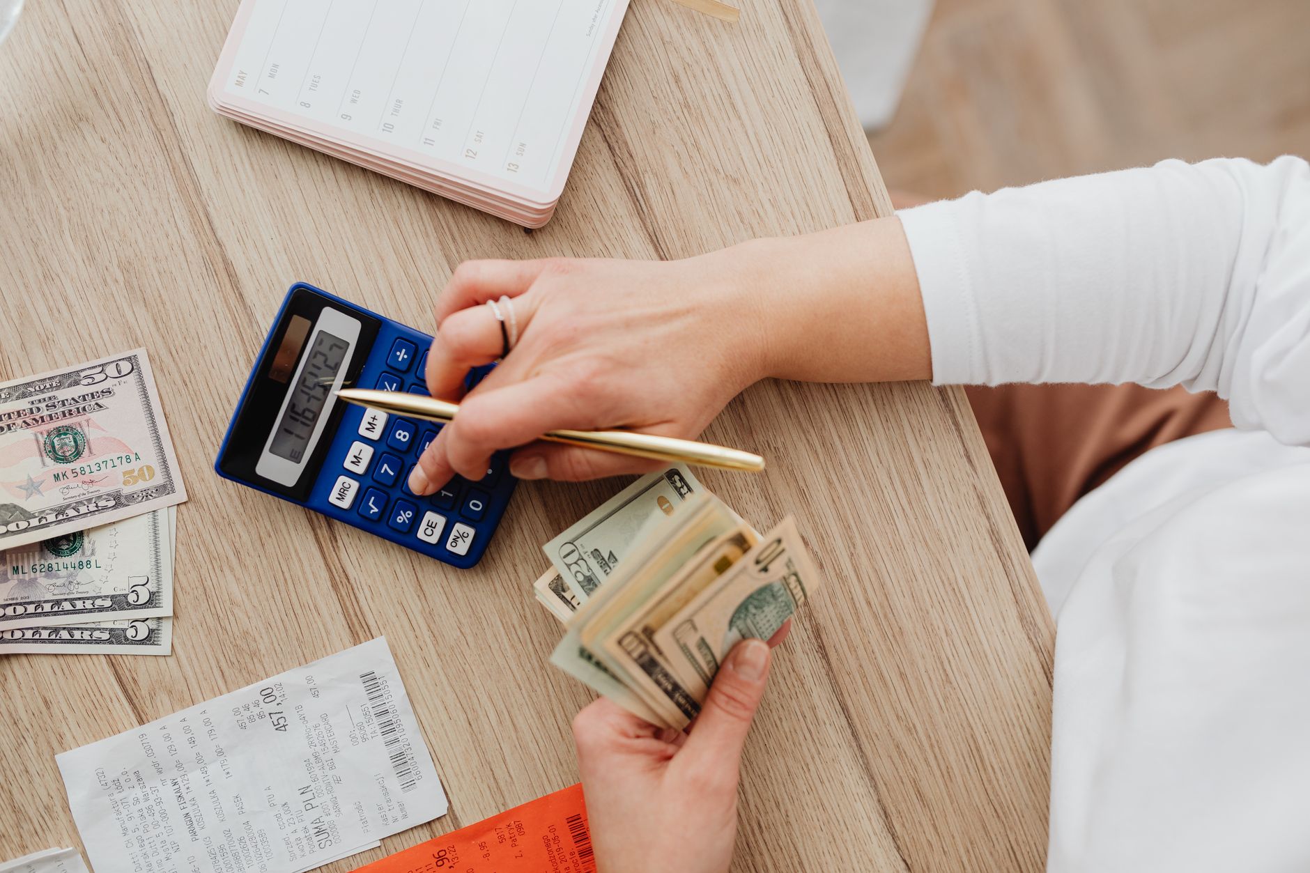 Business owner calculating CRM total cost of ownership on a laptop