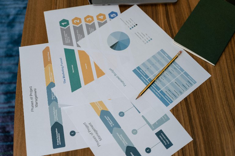 Analyst studying charts on a monitor to evaluate analytical CRM data