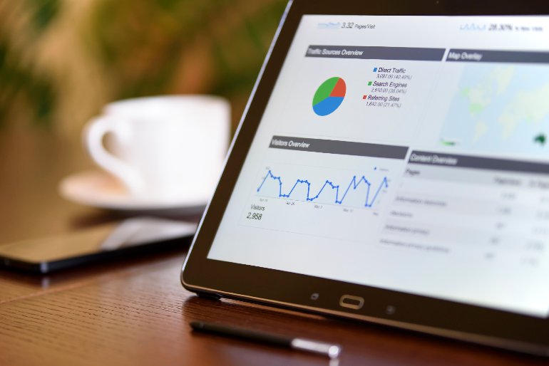 Sales manager analyzing CRM reporting dashboard with key metrics